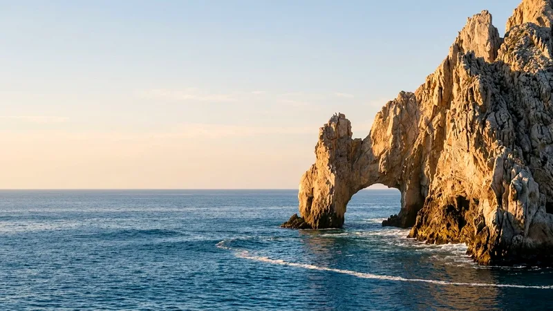El Arco rock arch at Land's End rising from deep blue sea at sunrise
