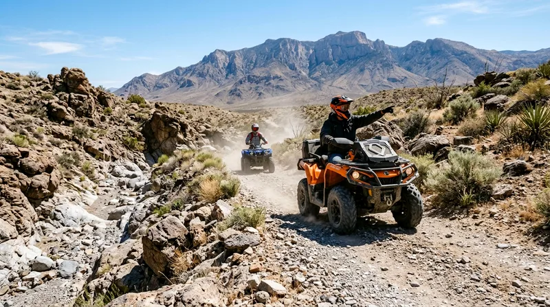 Two ATV riders on desert trail with guide leading toward mountains.
