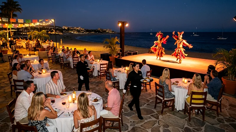 Audience seated at round tables watching costumed performers on a stage above Medano Beach.