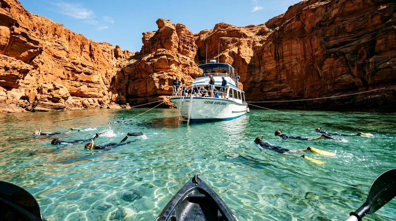 Tour boat anchored in turquoise cove at Espíritu Santo with snorkelers in water.